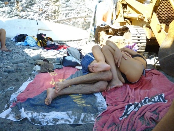 Life in Italy vs. Life in France: Italian are more at easy with getting sexy on the beach, like this intertwined couple on sandy towels.
