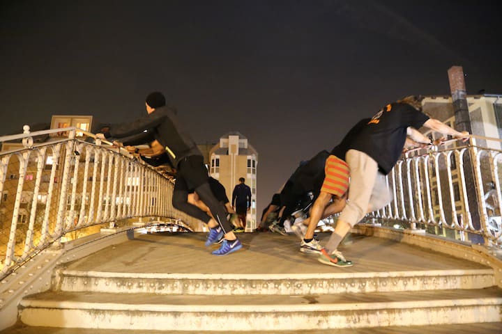 Running clubs in Paris are very popular and are a great way of getting to know the city, like this group of runners stretching on a bridge on the Canal Saint Martin.