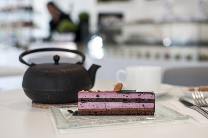 A pink chocolate Japanese cake at Paris bakery Sadaharu Aoki, with a pot of Japanese tea.