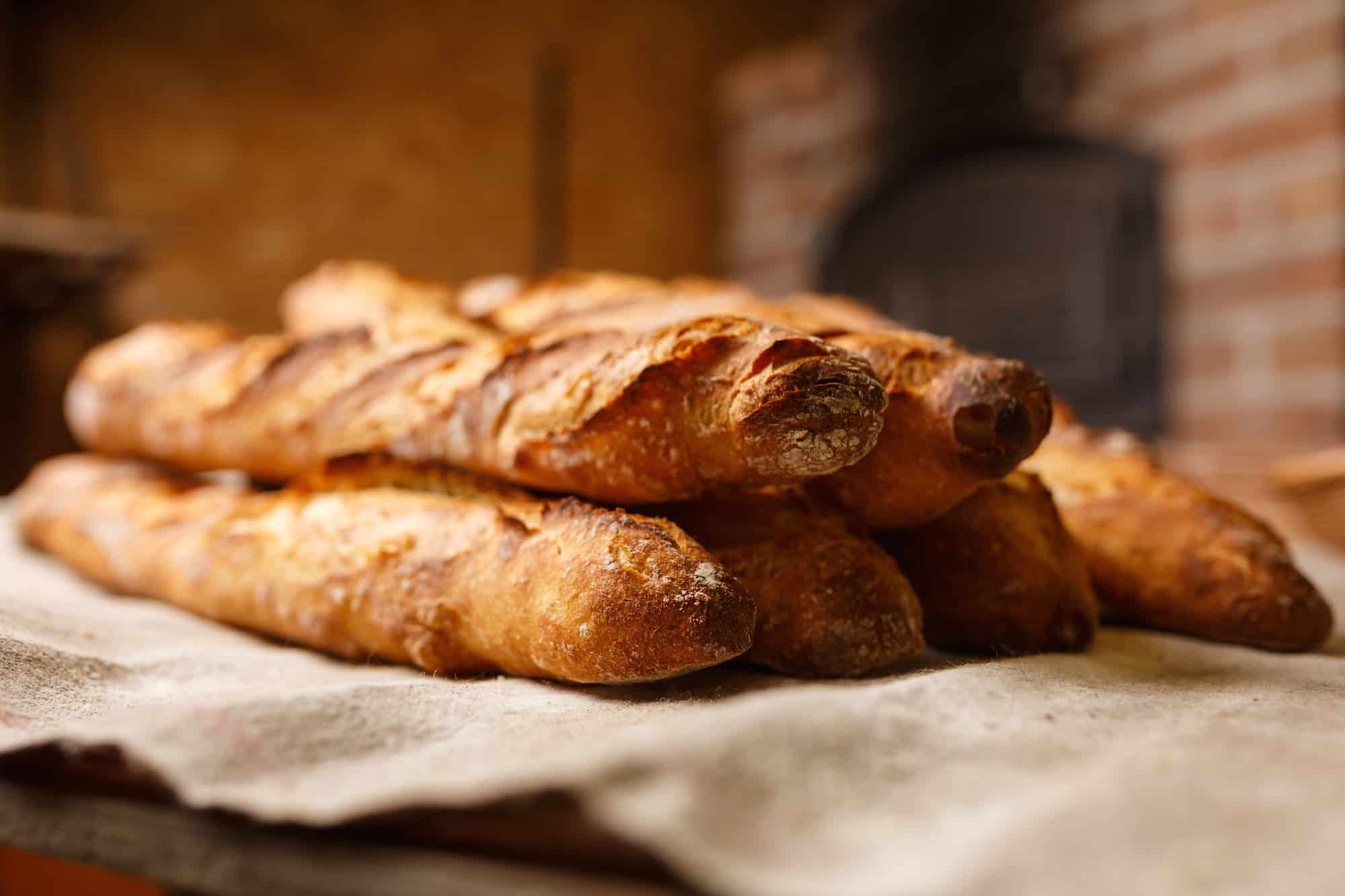 Four of the best bakeries in Paris' Abbesses area, that sell delicious crusty baguettes like these.