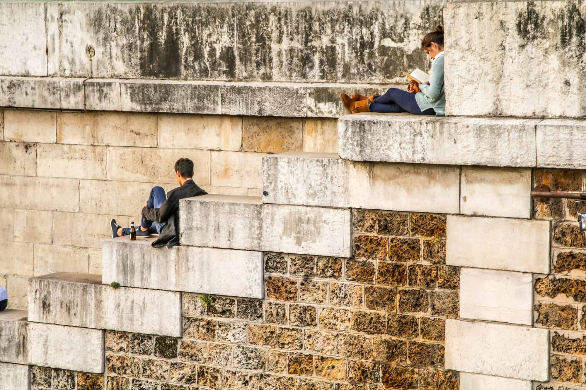 Paris in summer is quiet and it's possible to have its corners to yourself, like these two people reading quietly on the banks of the River Seine.