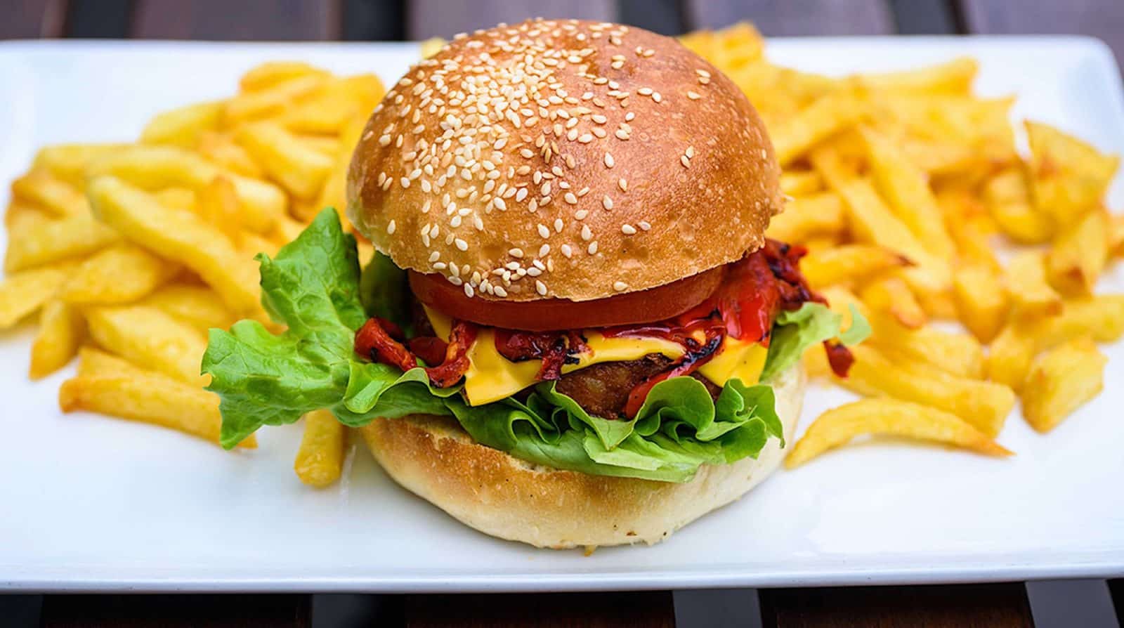 A juicy-looking vegan burger with fries at East Side Burgers restaurant in Paris.