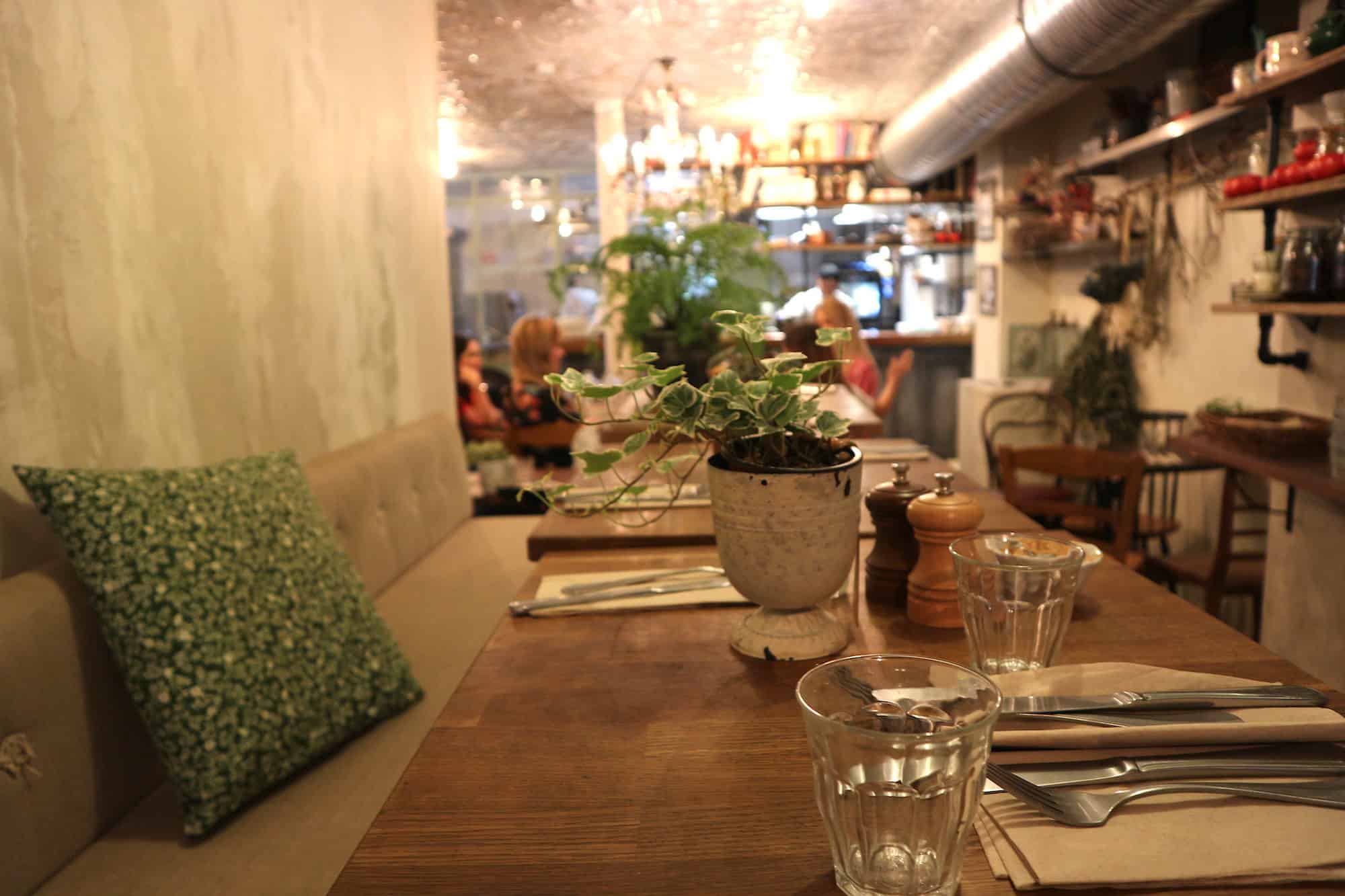 Inside one of the best coffee shops in Paris, Treize au Jardin, comes with wooden tables and cozy banquettes.