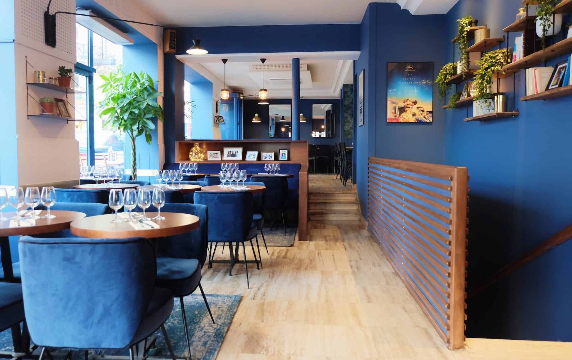 L'Invitée restaurant near Notre Dame Cathedral is one of our favorite spots to eat in Paris for the French food but also for the sleek and cheerful blue interiors
