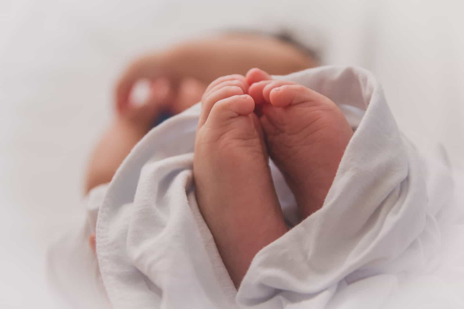 Questions about having a natural birth in Paris? Read on. Tiny feet of a new-born baby.