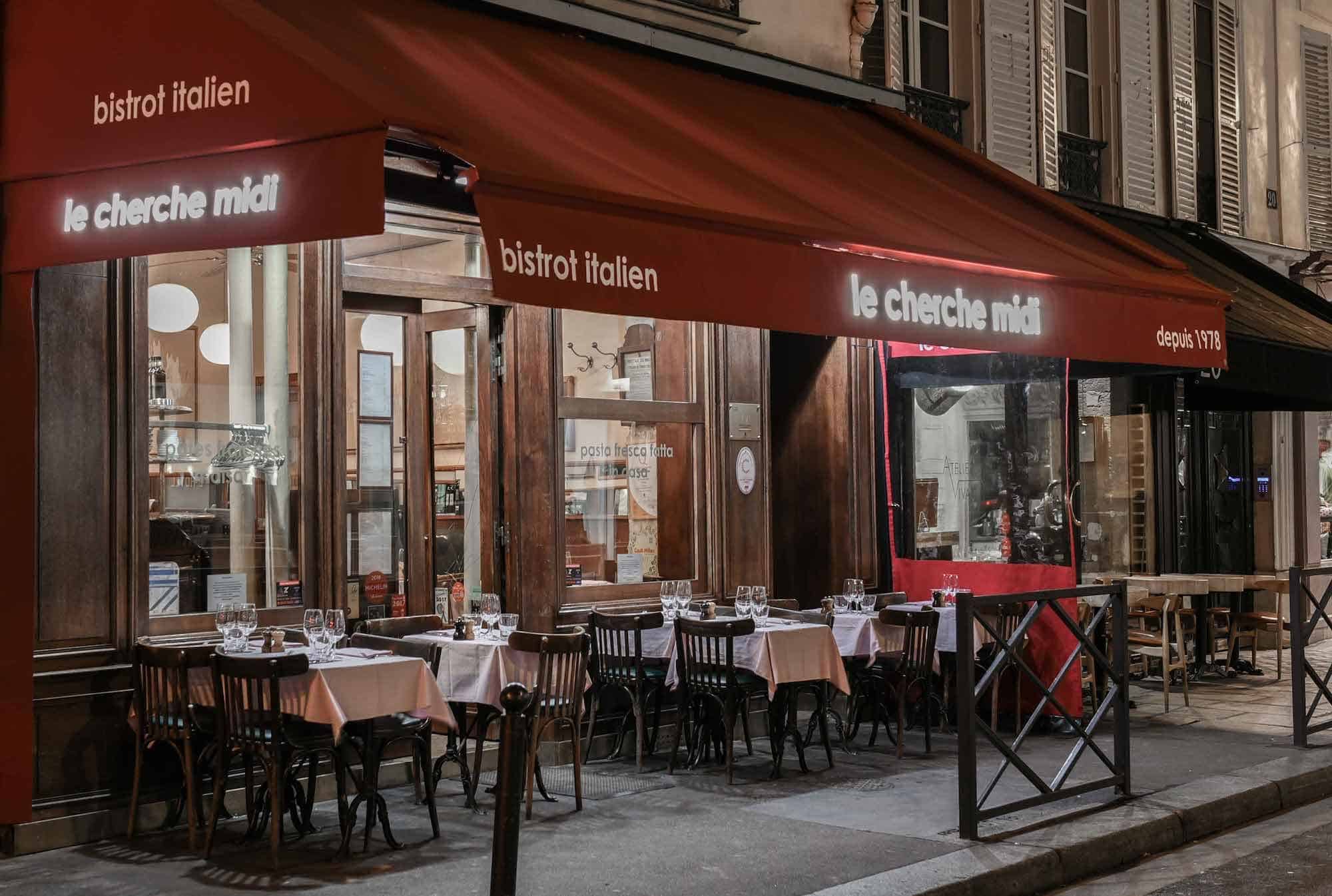 Some of Paris' best restaurants are to be found on rue du Cherche-Midi like this quaint bistro with a red awning over an outdoor terrace.