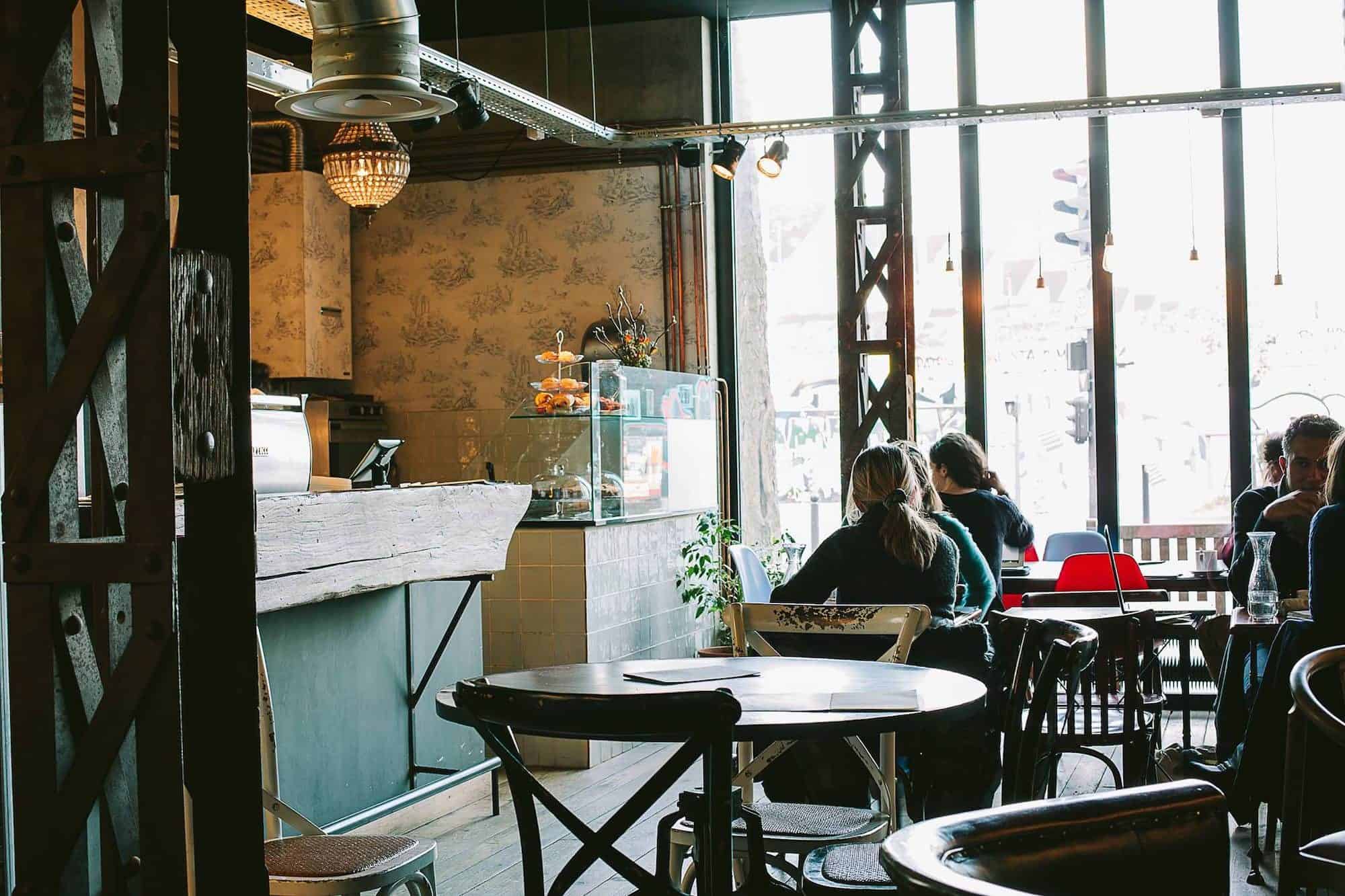Inside Paris gluten-free coffee shop Lomi and its exposed brick walls and distressed wooden chairs.