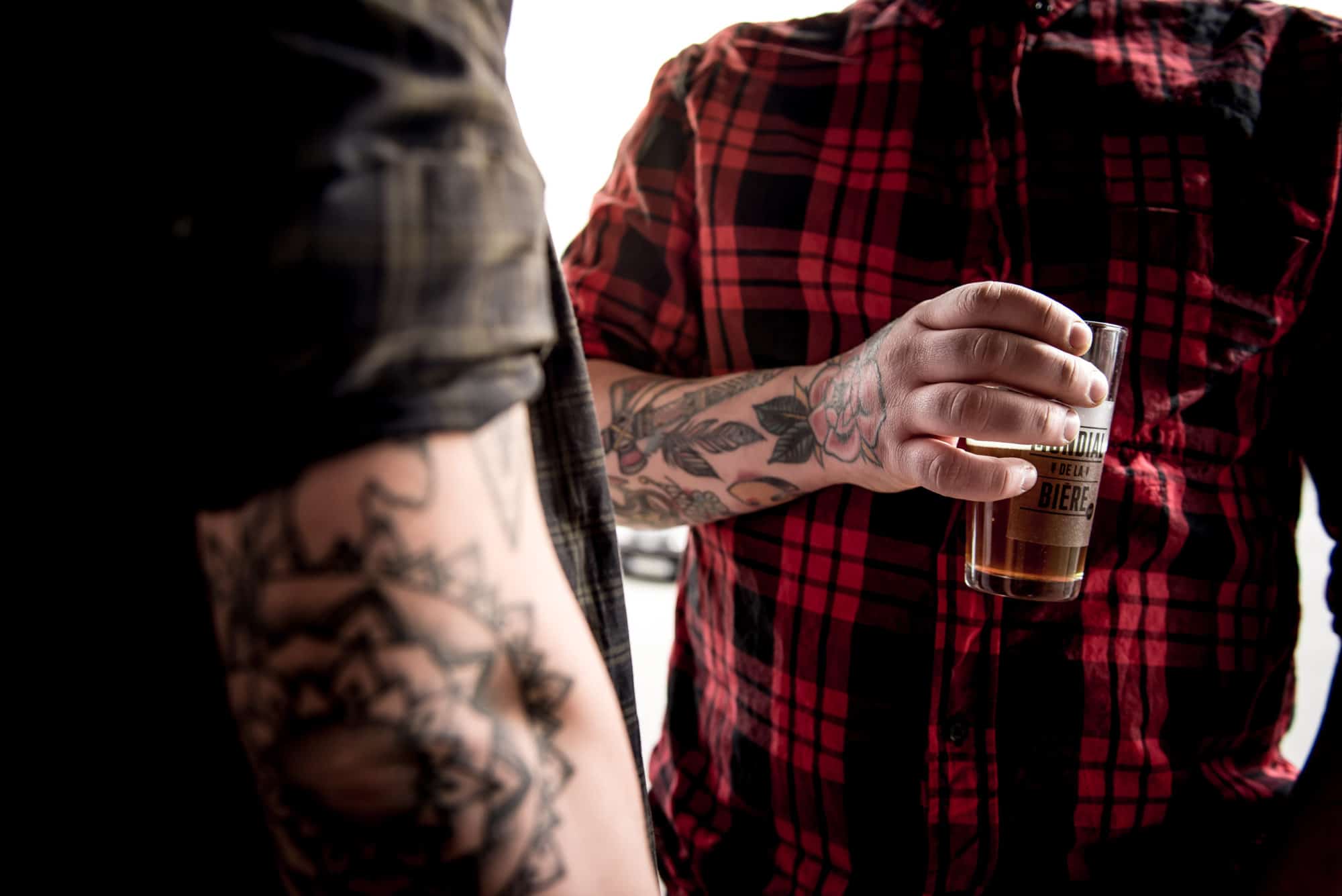 The Paris Beer Festival takes place in May, and allows you to taste lots of different craft beers like this tattooed man holding a glass of beer.