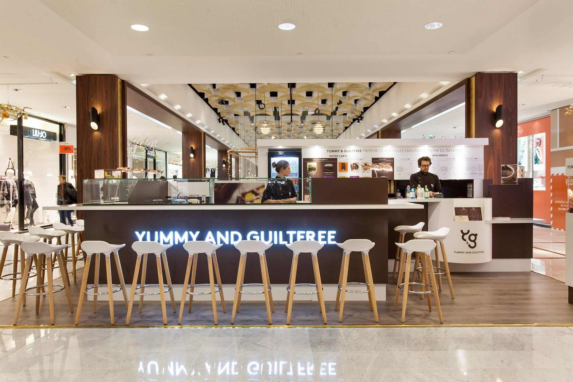 Yummy and Guiltfree, a gluten-free waffle shop in Paris, has a designer counter with a neon sign.