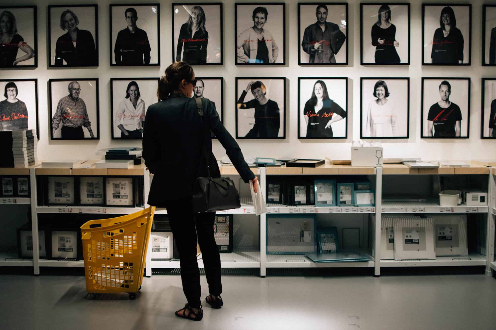 A customer standing in front of framed black and white posters at Ikea Paris La Madeleine