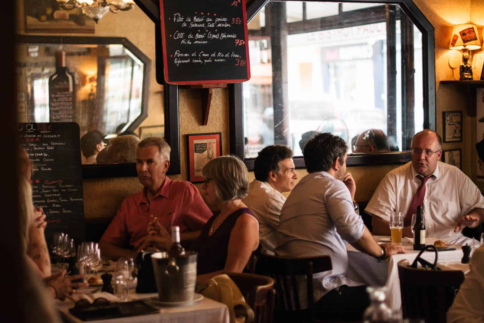 Diners seated at tables inside Le Chardenoux bistrot in Paris 11.