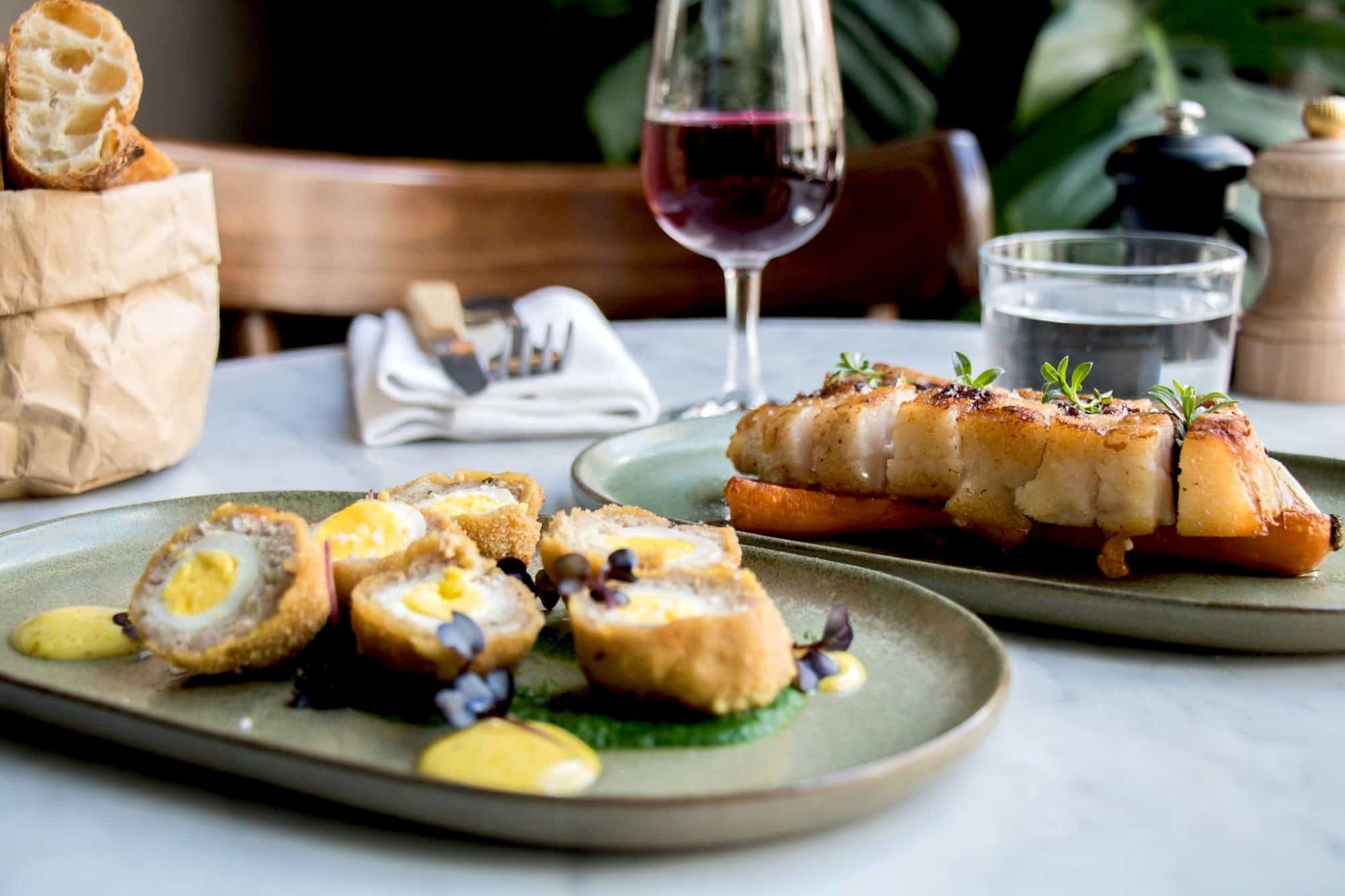 Le Relais' scotch eggs and a glass of red wine, in Paris.