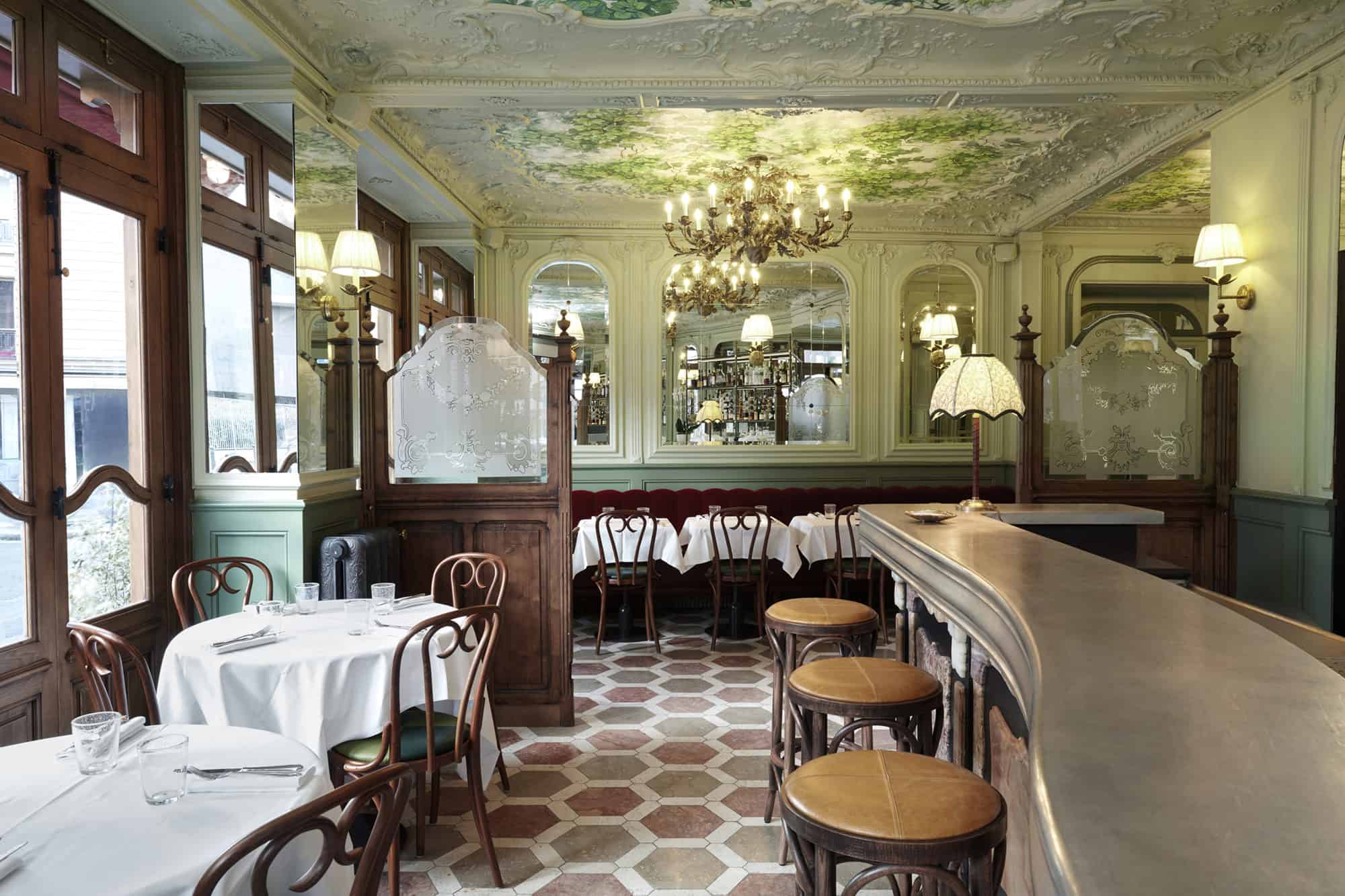 Le Chardenoux Paris bistrot Art Nouveau interiors with wooden tables, white table cloths and beautiful ceiling frescoes.