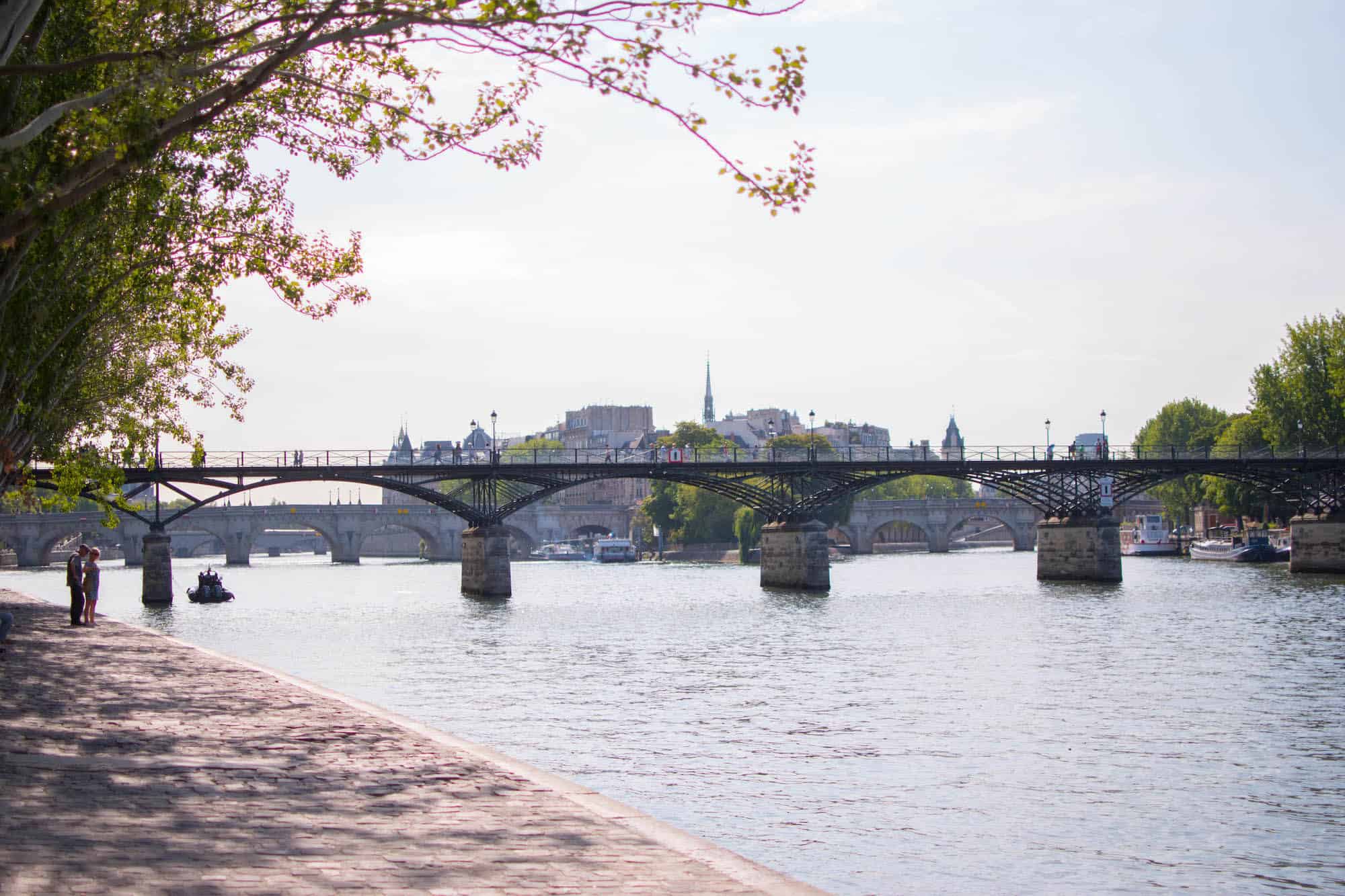 The Pont des Arts, a famed bridge in Paris, mainly known for where where the love lock trend started, with Notre Dame's spire peeking out from behind.