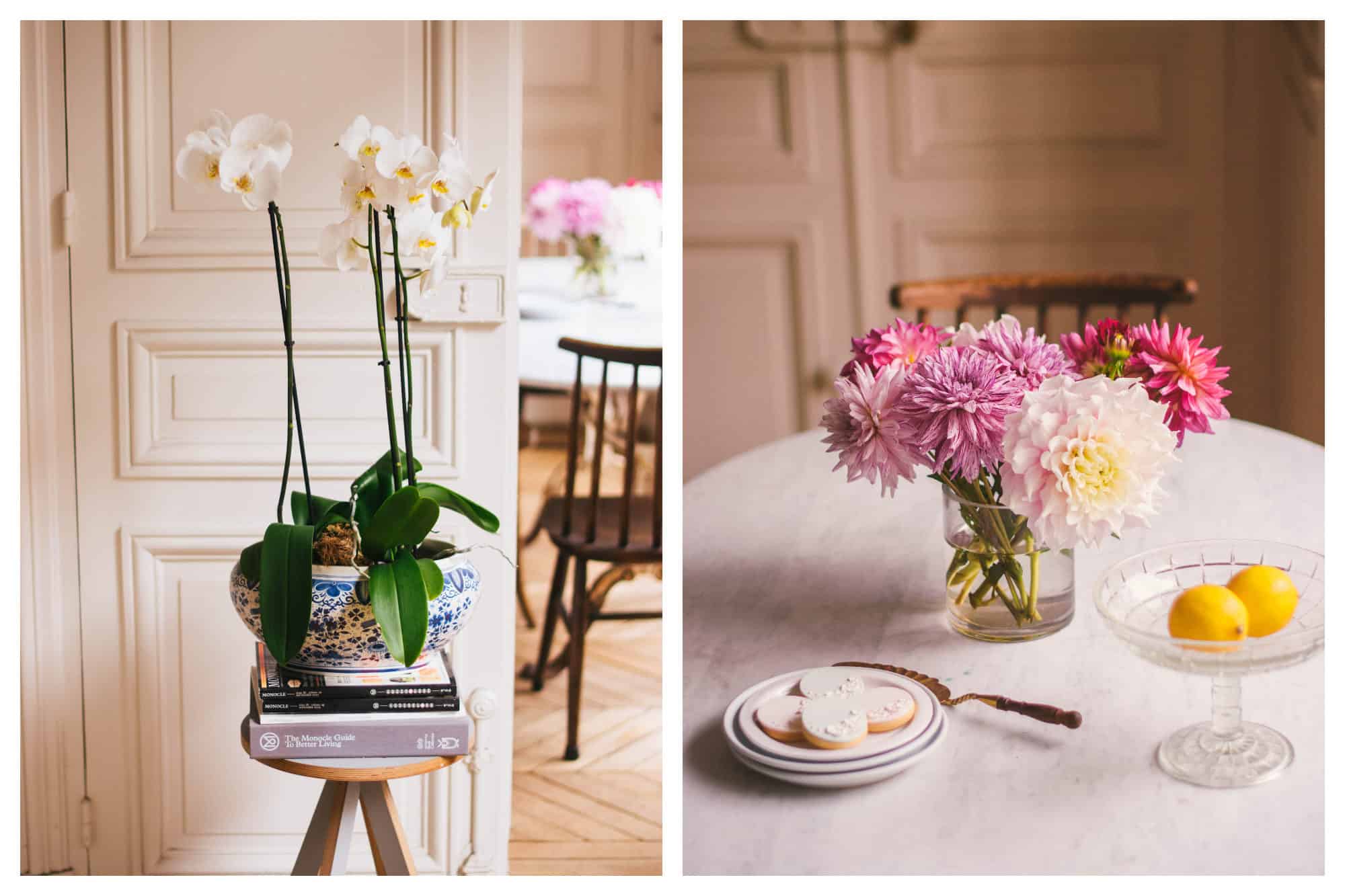 A ceramic pot of white orchids standing on books on a wooden stool inside Frank's dreamy Paris apartment (left). A vase of pink and purple dahlias on a table next to some of Frank's biscuits (right).