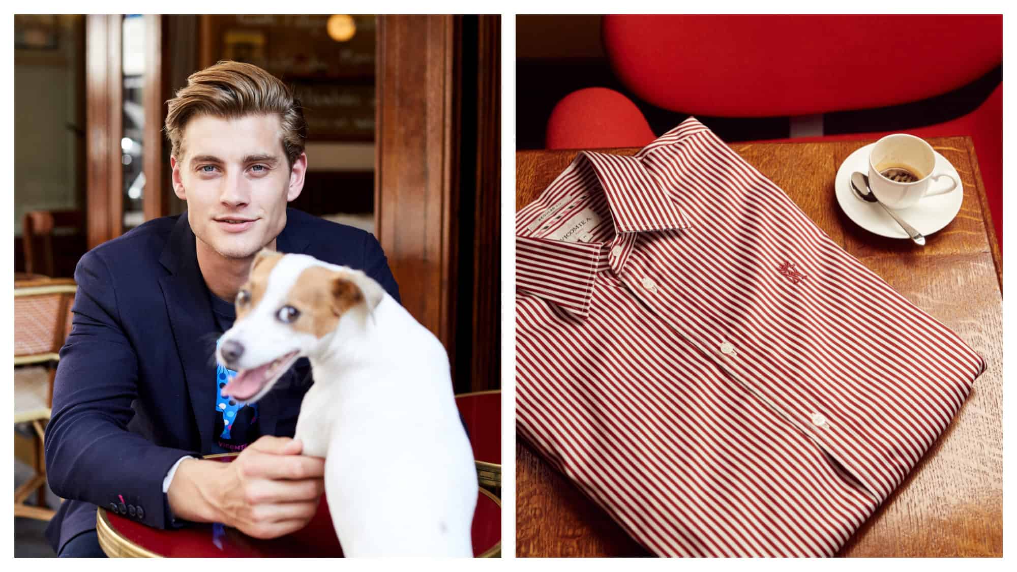 A male model at a Parisian café, wearing a navy sweater, with his dog (left) and a striped red and white shirt on a wooden desk next to an empty cup of coffee (right) from French menswear brand Vicomte A. 