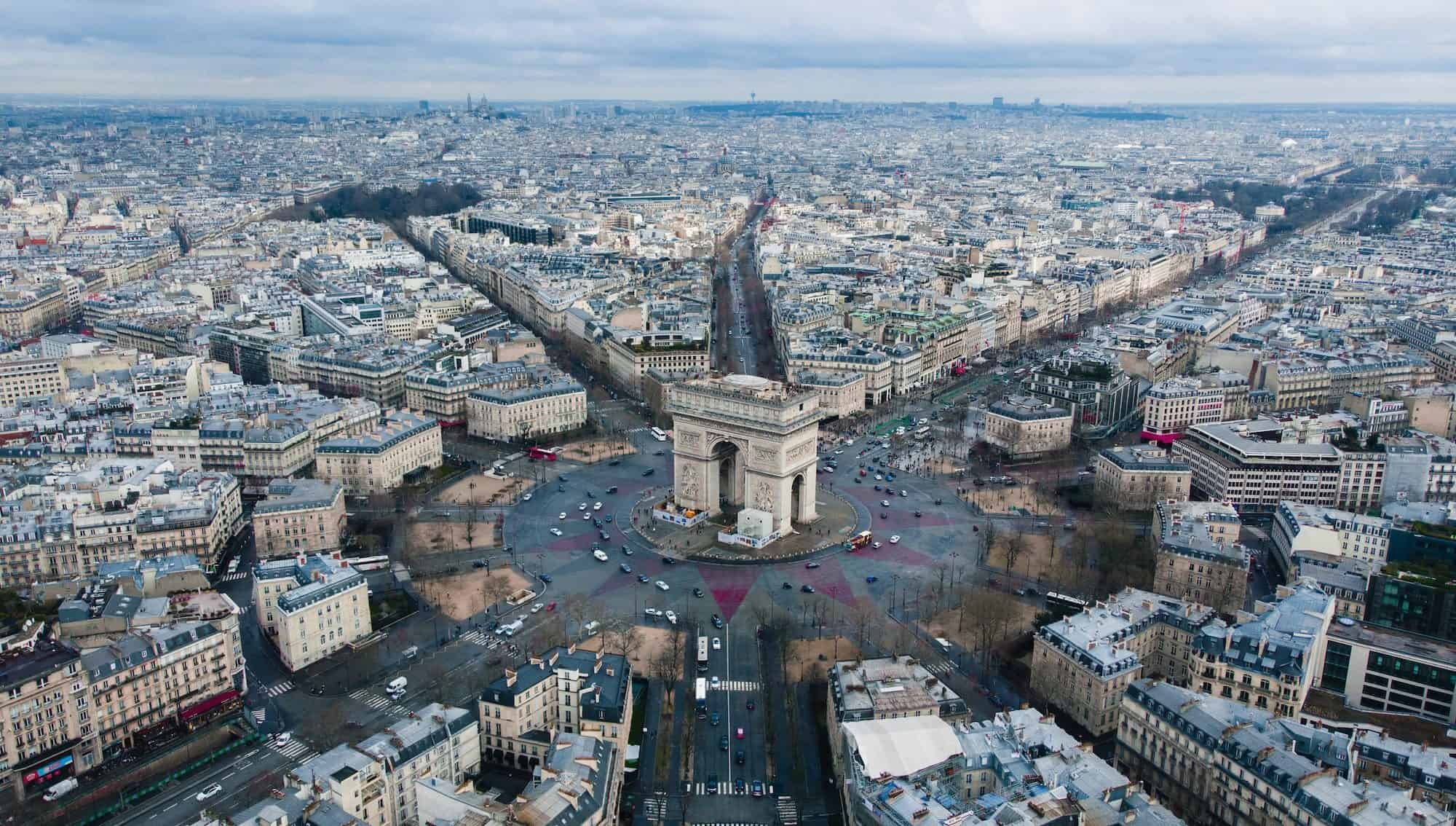 An aerial view of the Arc de Triomphe in Paris, often seen in Netflix movies, which are great for learning French.