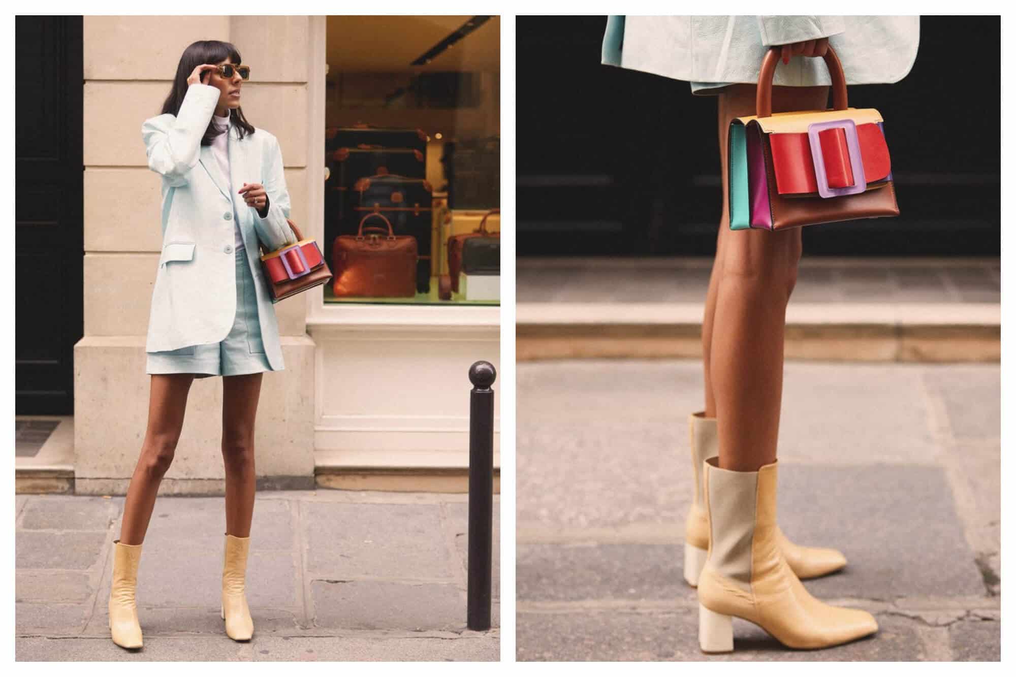 Left: a woman standing on a Parisian footpath in front of a shop window. She's wearing a pale blue blazer and matching shorts, with sunglasses, a multicolour handbag, and tan heeled boots. Right: a close up of the same woman's legs with the handbag and boots.