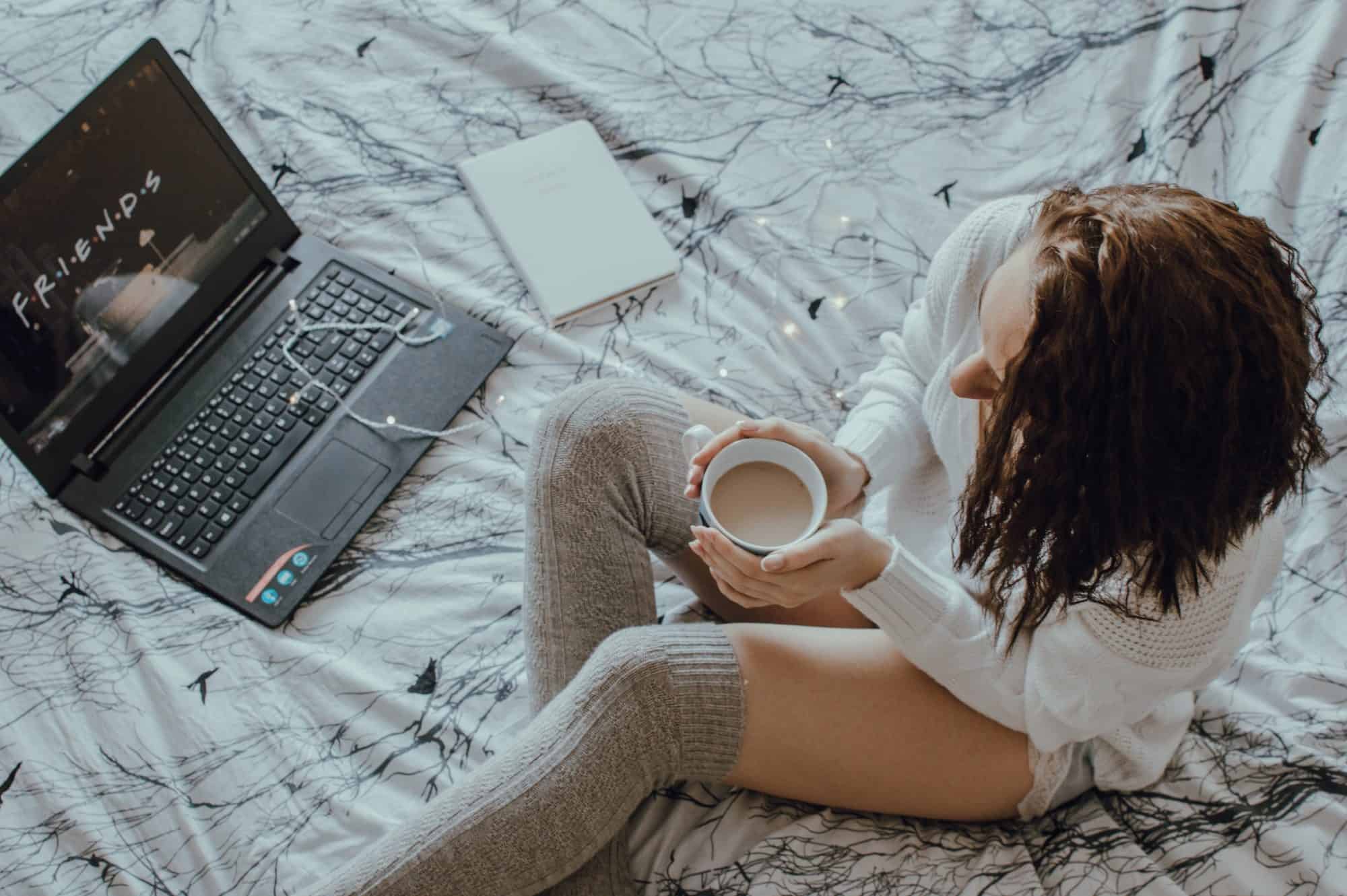 A girl in her pyjamas, watching series like Friends reruns during the Paris lockdown.