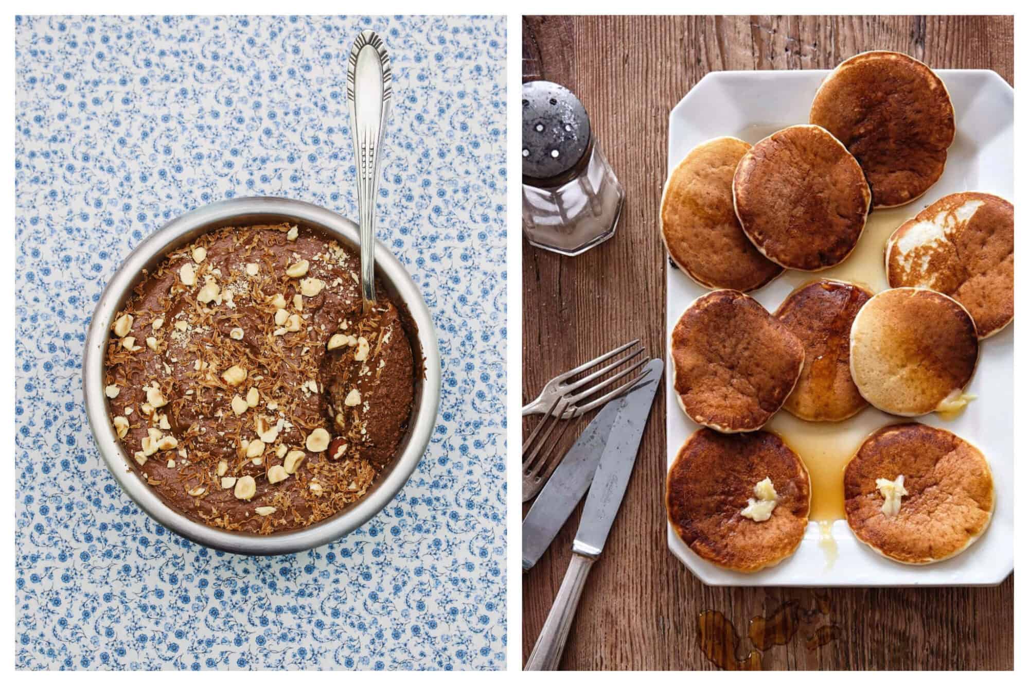 Left: a bowl of chocolate mousse on a blue and white floral background, with a spoon inside, and peanuts sprinkled on top.
Right: a plate of pancakes on a wooden table with silver cutlery and a sugar shaker. The pancakes are on a white plate with maple syrup and butter on top. 