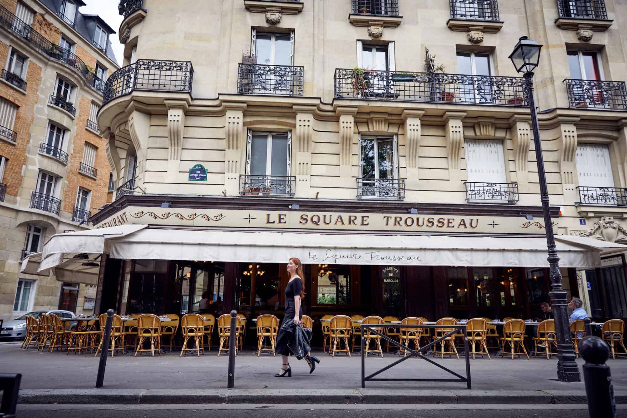 A café and its terrace laid out under its awning in Paris.