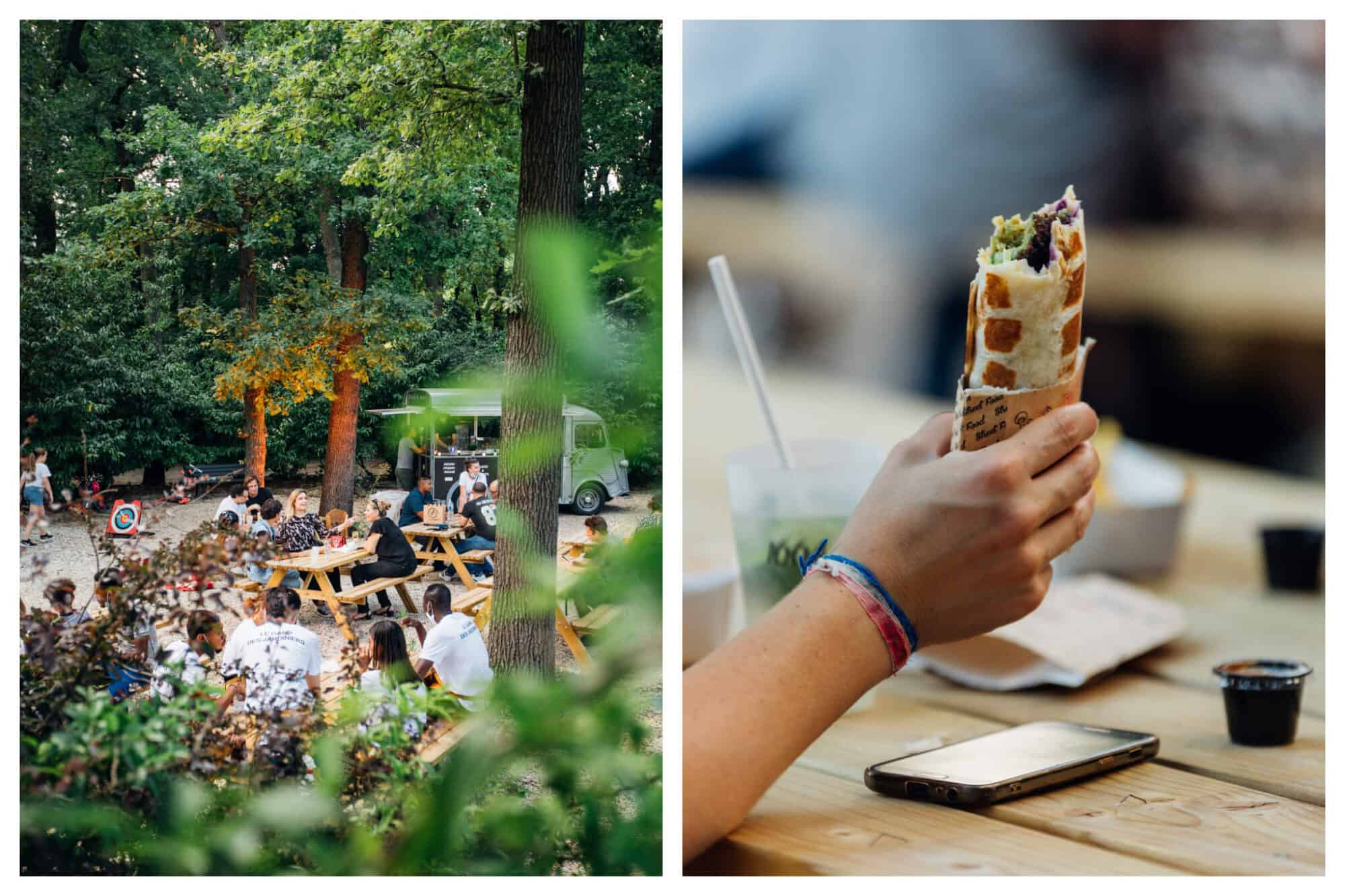 Left: people seated at wooden bench tables surrounded by greenery. Right: a wrap in the hand of a person seated at a wooden bench table. There is a drink on the table as well as a dipping sauce and an iPhone. 