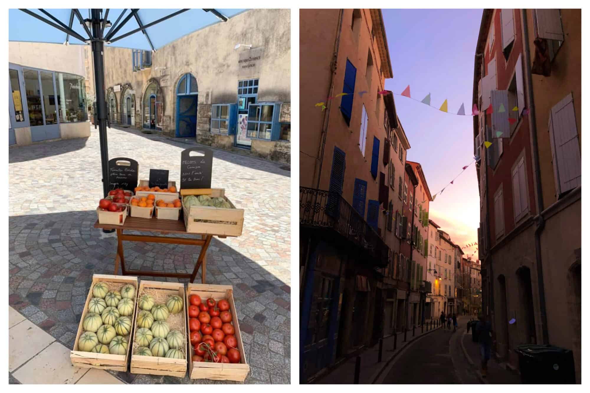 Left: Fresh produce, including cantaloupe and tomatoes, sit in wooden produce boxes at Fraîcheur et Délices in Arles, Right: A colorful street in Provence, lined with small triangle flags, is empty just after sundown.