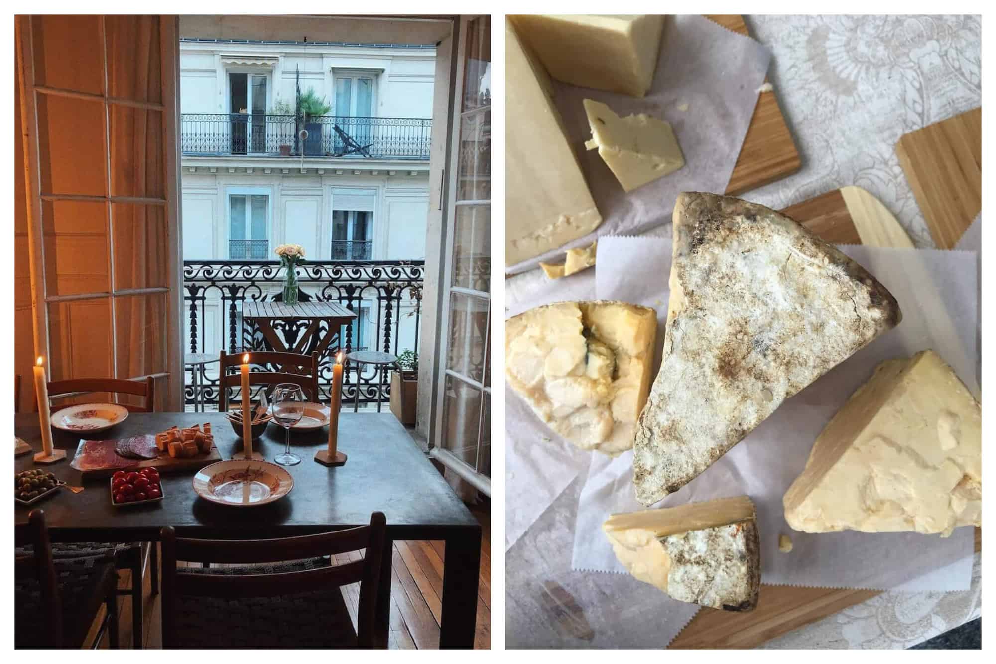 Left: a table set with plates, candles, a wine glass and food with a large window overlooking Paris in the background. Right: several pieces of cheese on a cutting board as seen from above.  