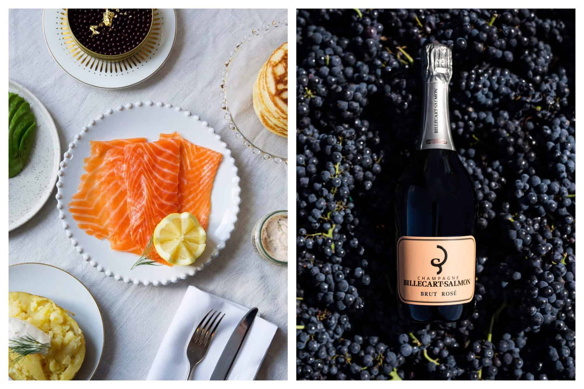 Left: an aerial view of a plate of smoked salmon. There is a half of a lemon on the plate as well. There are other food items slightly visible including blinis, avocado, caviar, and a small jar of sauce. Right: A bottle of billecart Salmon champagne laying on a bed of dark blue grapes. The label is salmon colored and there is silver aluminum at the top of the bottle.
