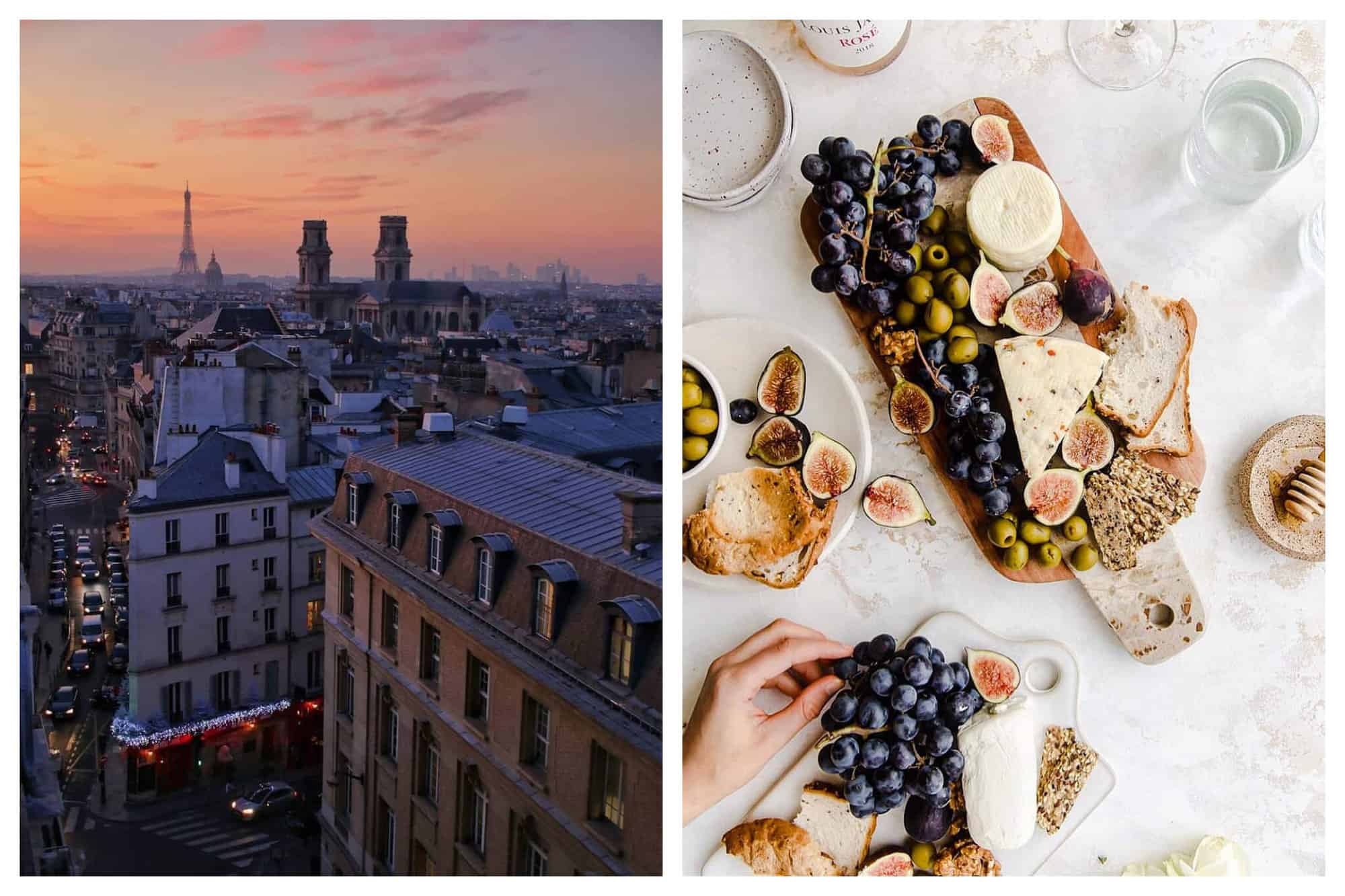 Left: a view of Paris. There are several buildings and the Eiffel Tower can be seen in the distance. The sun is setting and the sky is pink and orange. There are Christmas decorations visible on a café on a street below. Right: an aerial view of a cheese platter. There are several pieces of cheese as well as grapes, figs, and olives. There is also bread. To the left is a smaller cheese platter and a plate, both filled with cheese and fruit. 