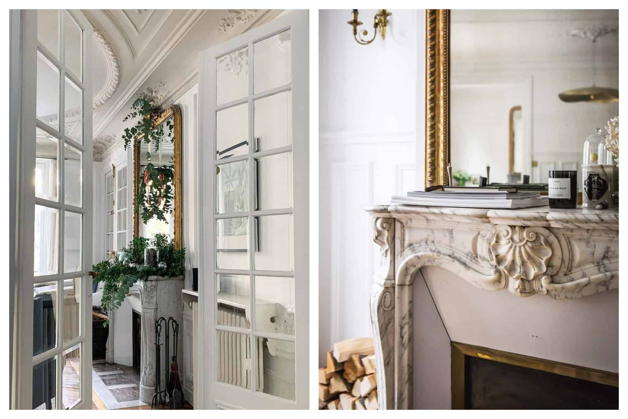 Left: within an apartment, white glass panel doors are ajar, opening to a white room with hanging plants and a large gold mirror above the fireplace. Right: A similar image of an up close marble fireplace with books and candles on the mantelpiece and a large gold mirror resting above. A small pile of wood is pictured beside the fireplace. 