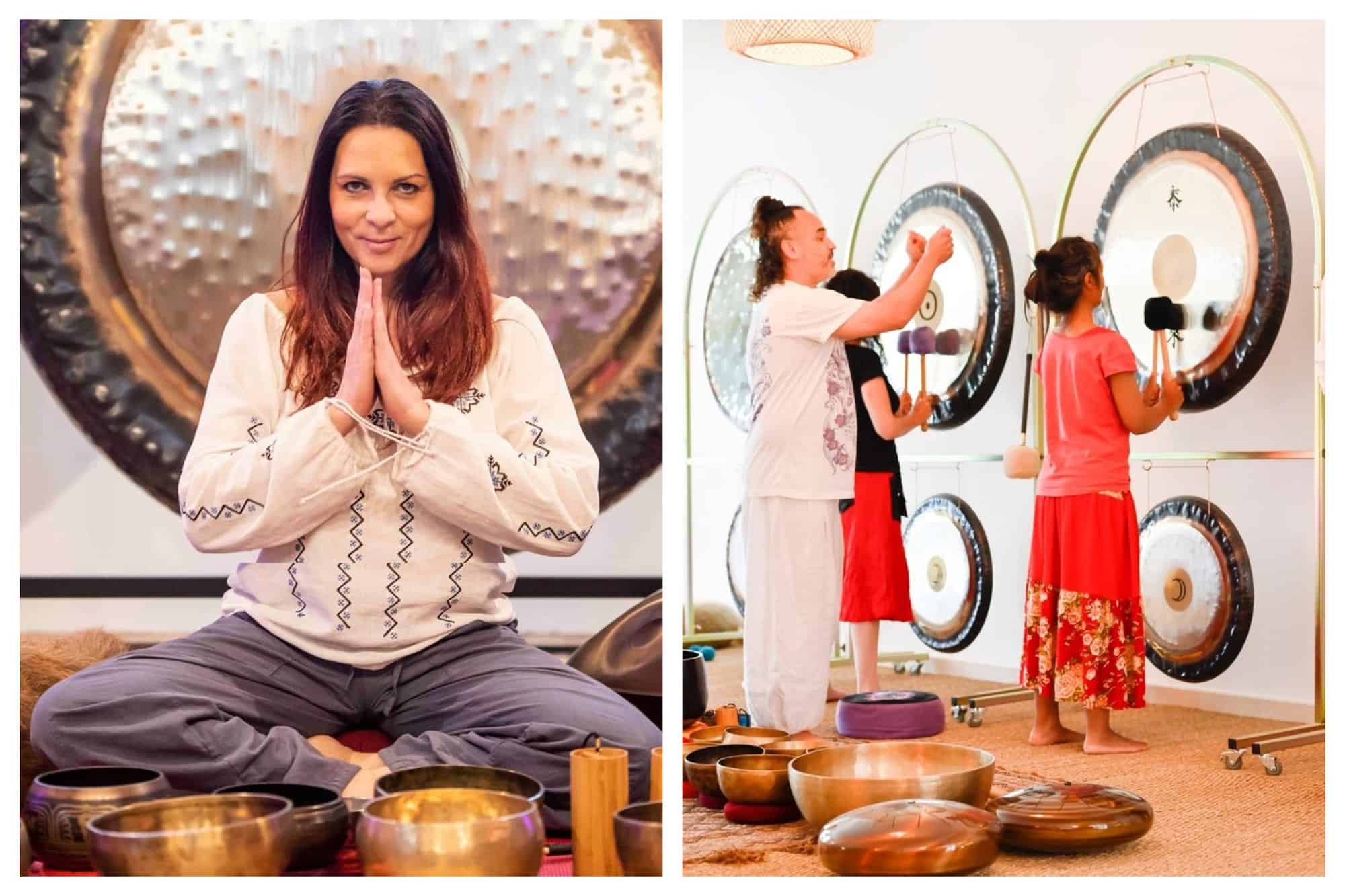 Left: Ellie from Zen and Sounds in a seated namaste pose in front of her sound bowls. Right: Swan from Zen and Sounds is instructing two participants on the use of sound gongs.