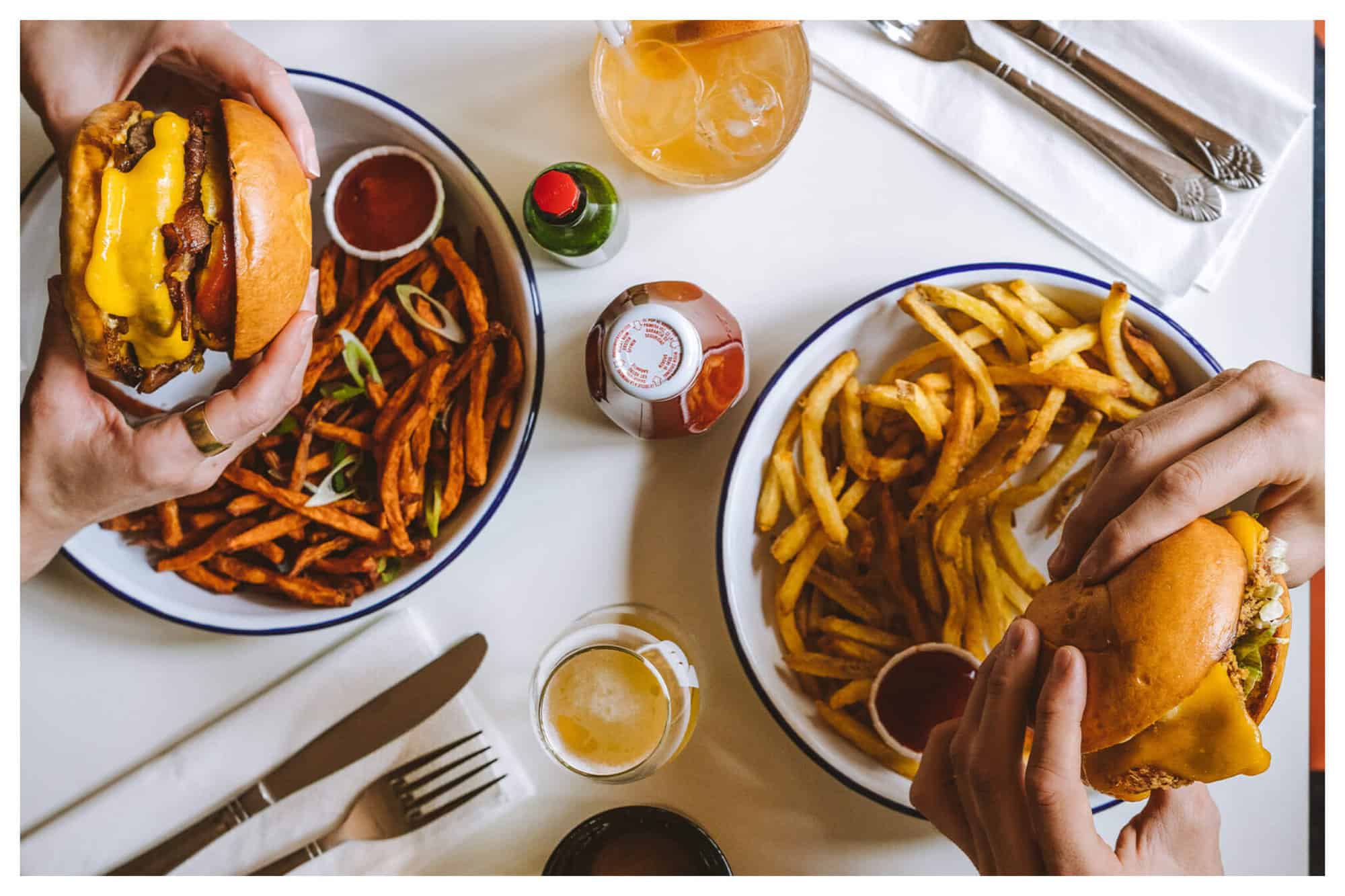 two people sharing burger and fries at PNY 