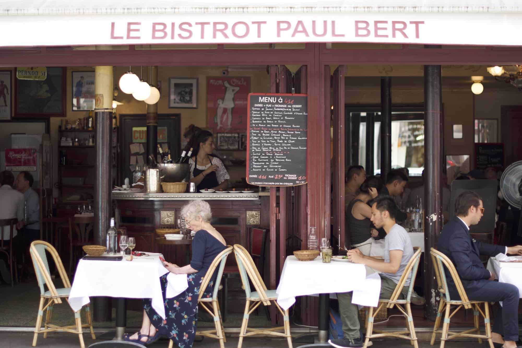 People sitting on the terrace outside the Paris restaurant Bistrot Paul Bert.