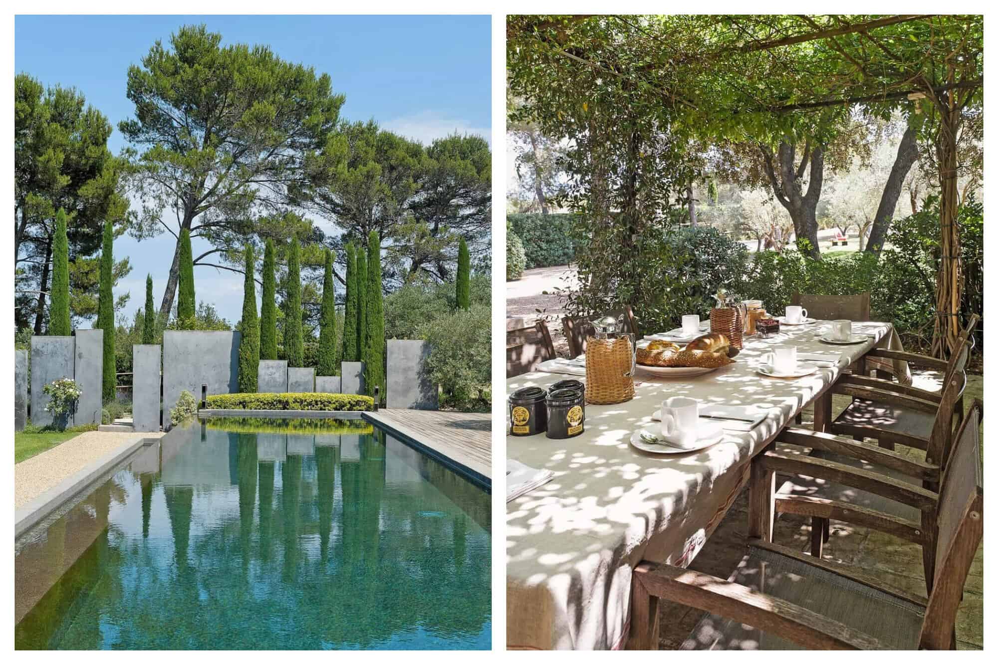 The long blue pool of St Remy Zen reflects the surrounding cypress trees . A shaded terrace has a table set for lunch with baguettes and condiments.