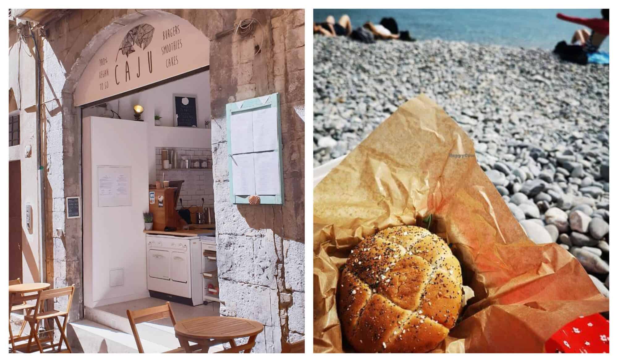 Left: A view of Caju restaurant from the exterior with wooden tables in front. Right: Sitting on a rocky beach in Nice with a view of the water in the background, someone holds a sandwich wrapped in brown paper from Caju restaurant.