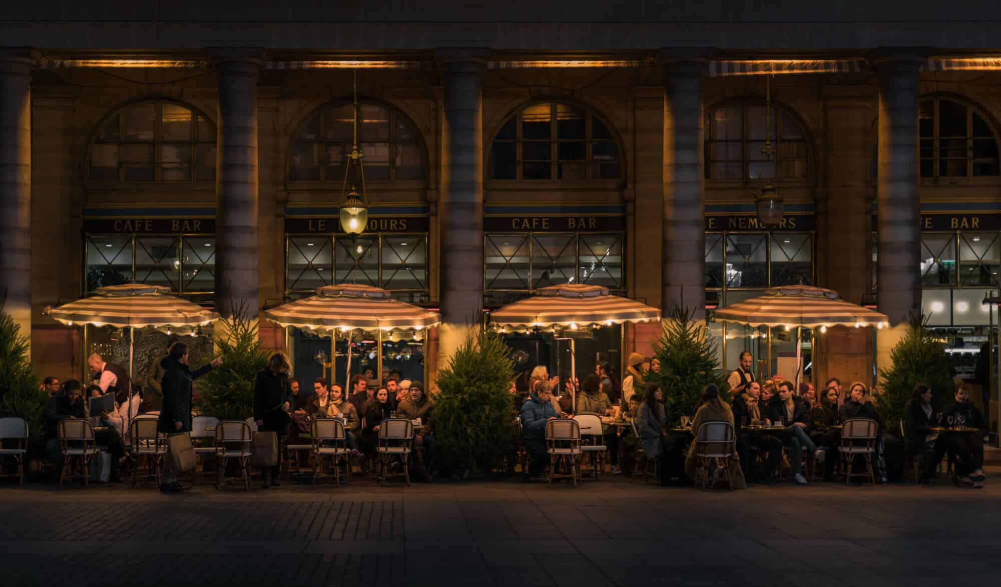 A view of the terrace of Paris cafe Le Nemours at night. 