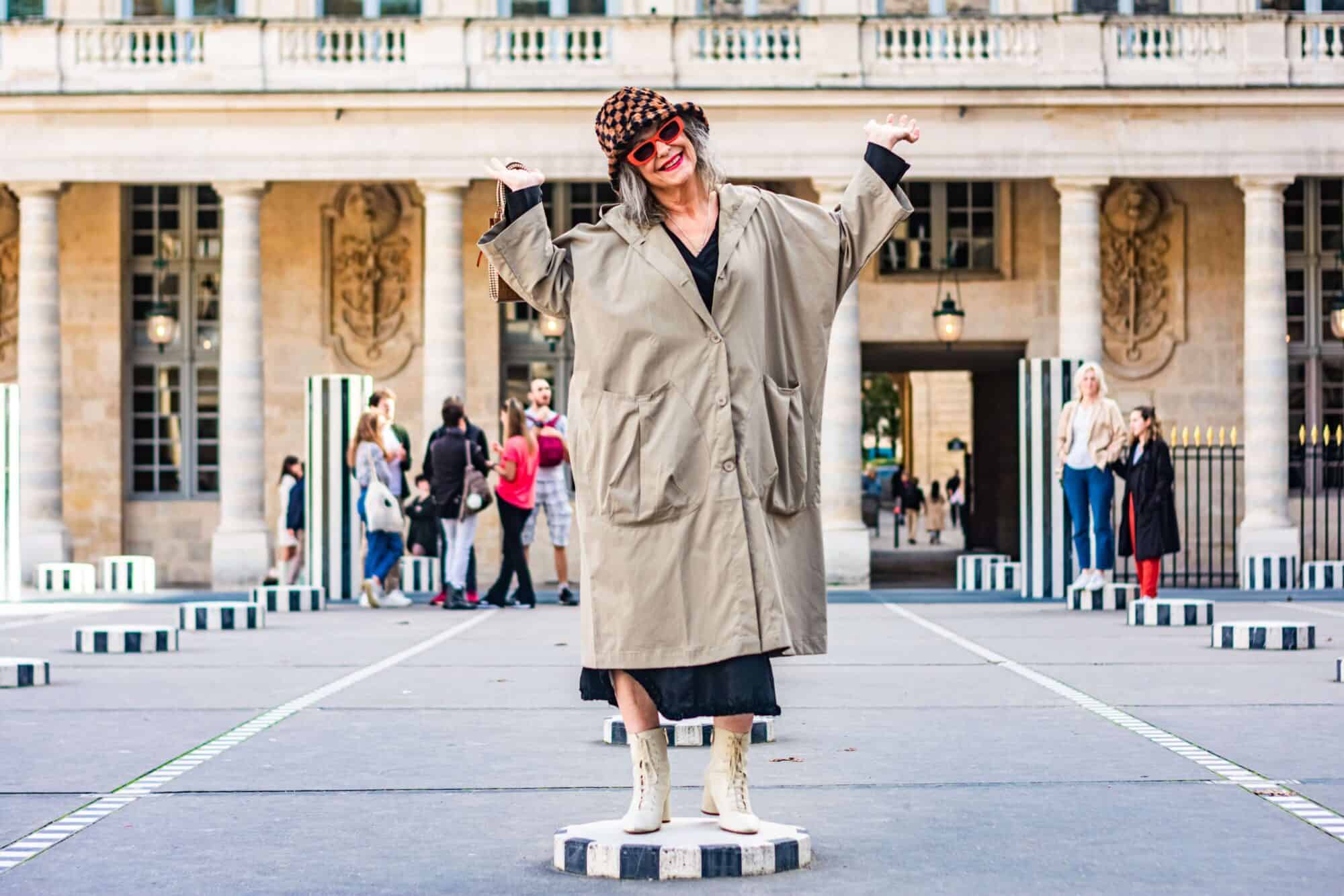 A woman displays an infectious smile while posing by the Palais Royal. 