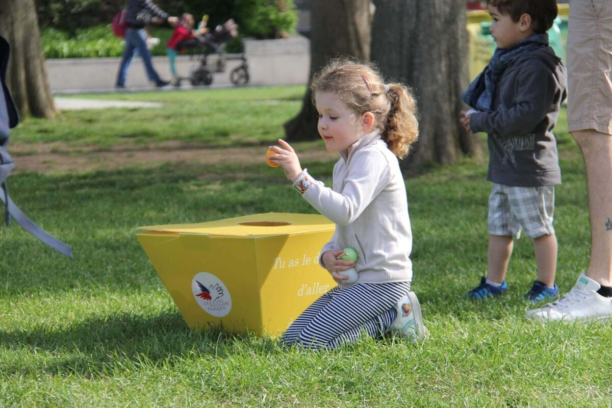 A little girl hunting easter eggs on Easter Weekend.