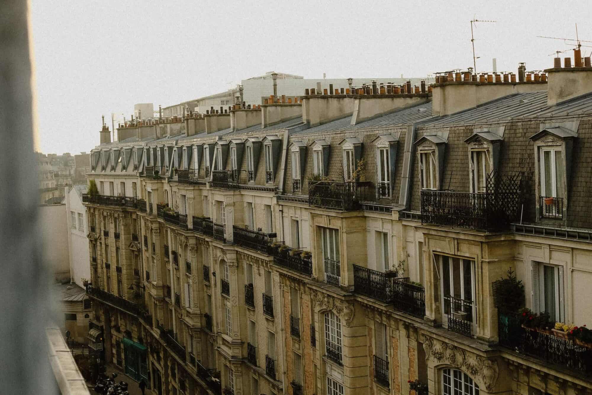 A faded view of Parisian facades of the buildings from the top floor of an apartment somewhere in Paris.