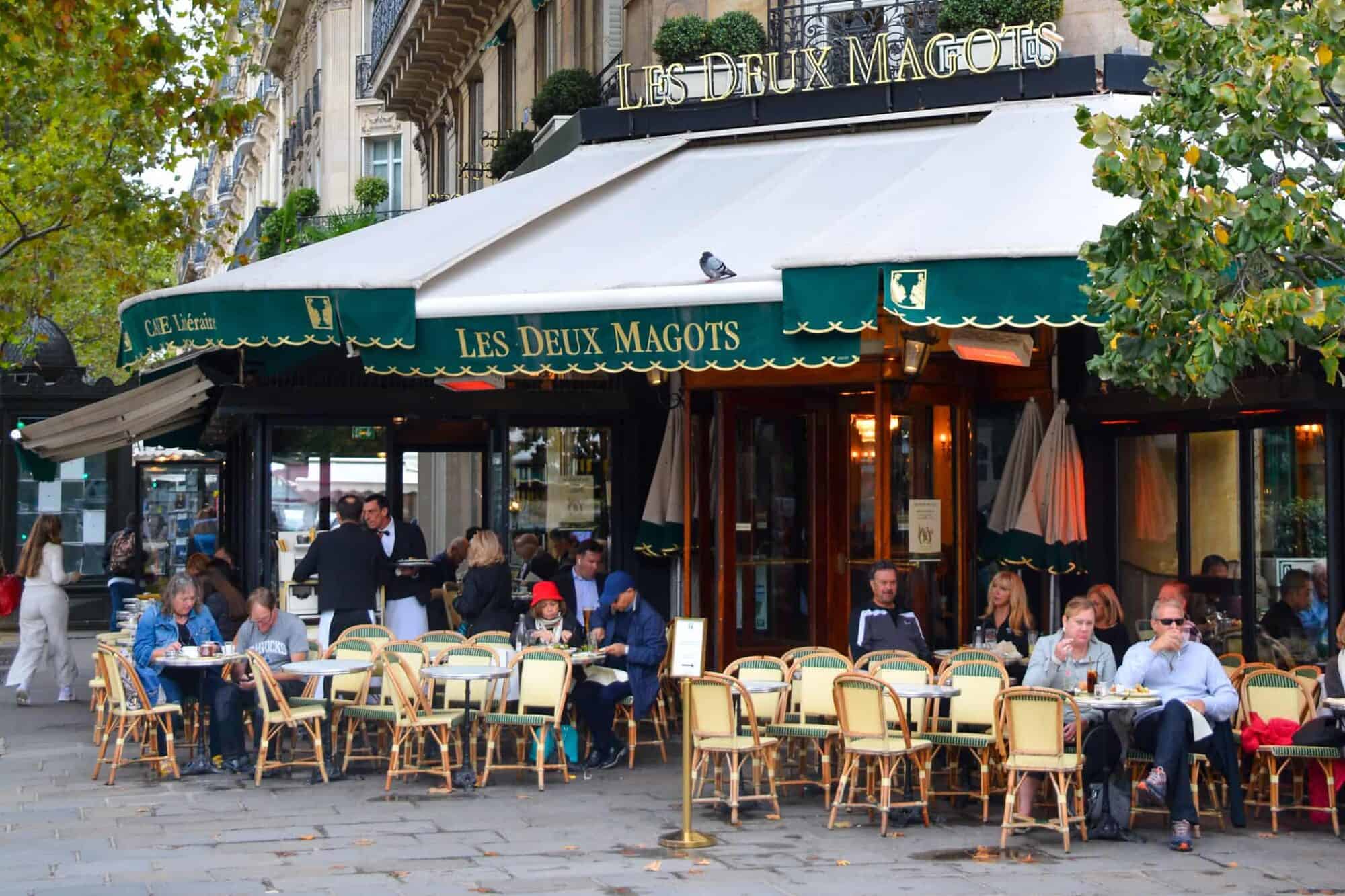 A view of the street corner on which the famous Deux Magots Parisian café is situated with its iconic green awning.