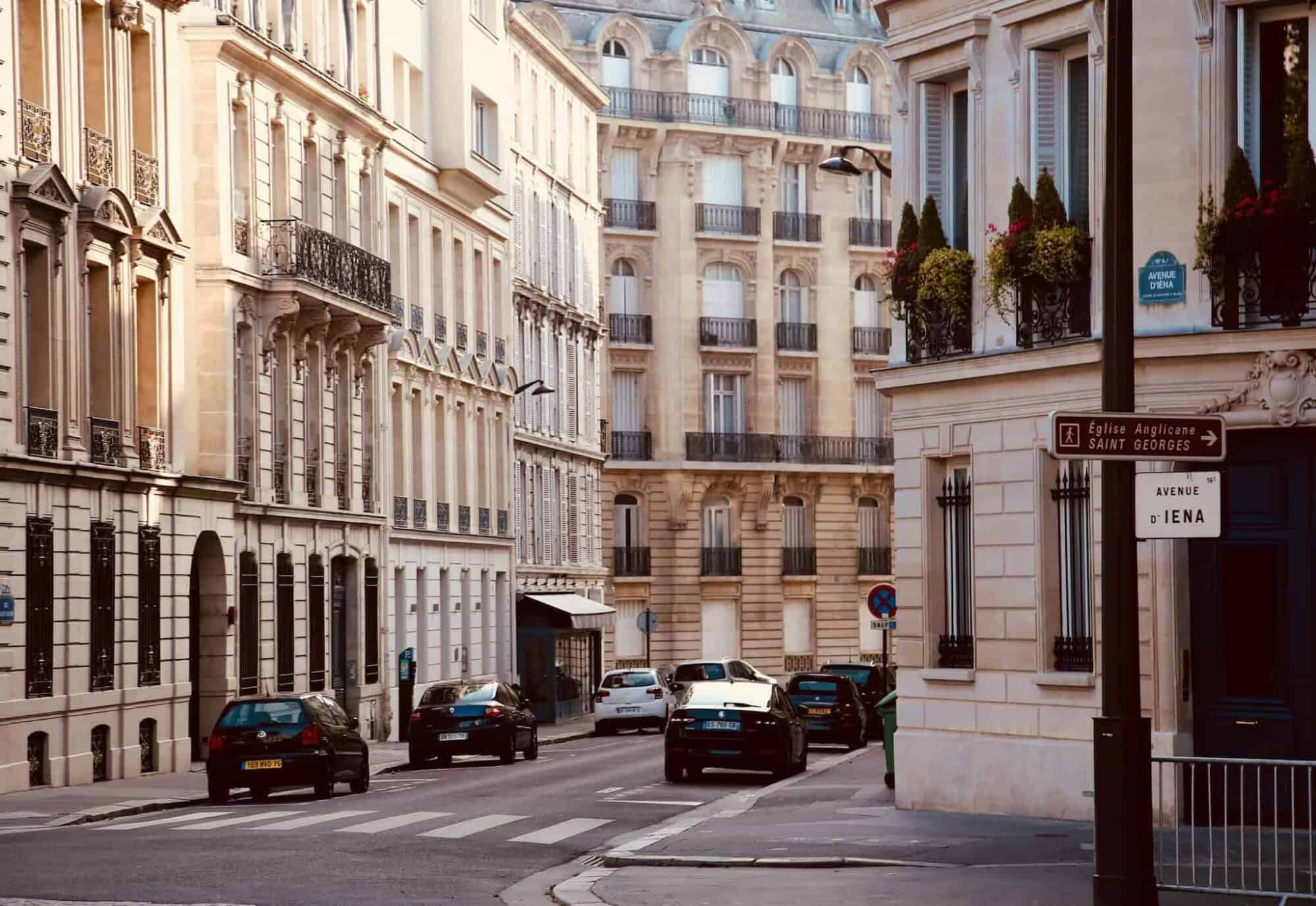 The cross street of beautiful exterior Haussmann buildings.