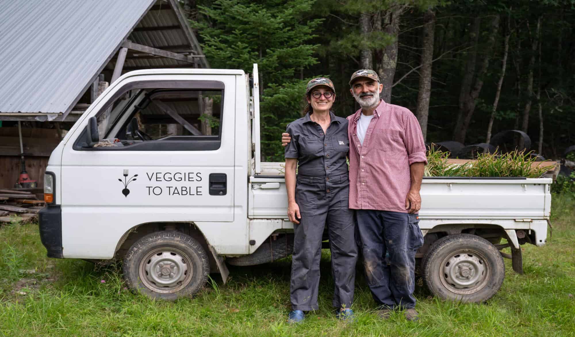 Erica Berman & Alain Ollier stand in front of a truck at Veggies to Table, Maine