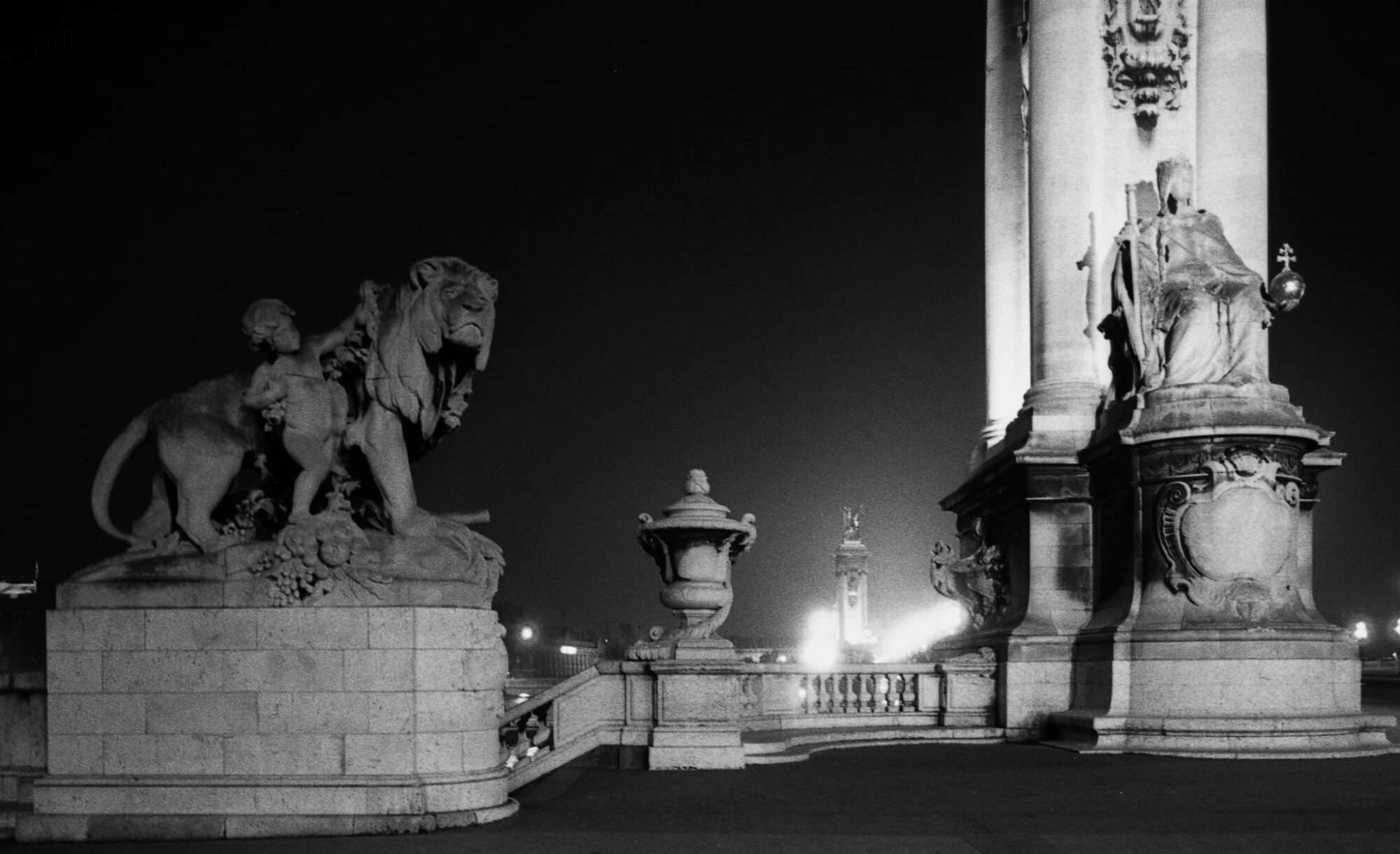 An eerie view of Pont Alexandre at night in black and white.