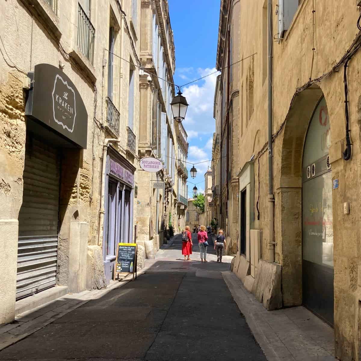 A narrow passageway between stone buildings in the Old Town Montpellier.