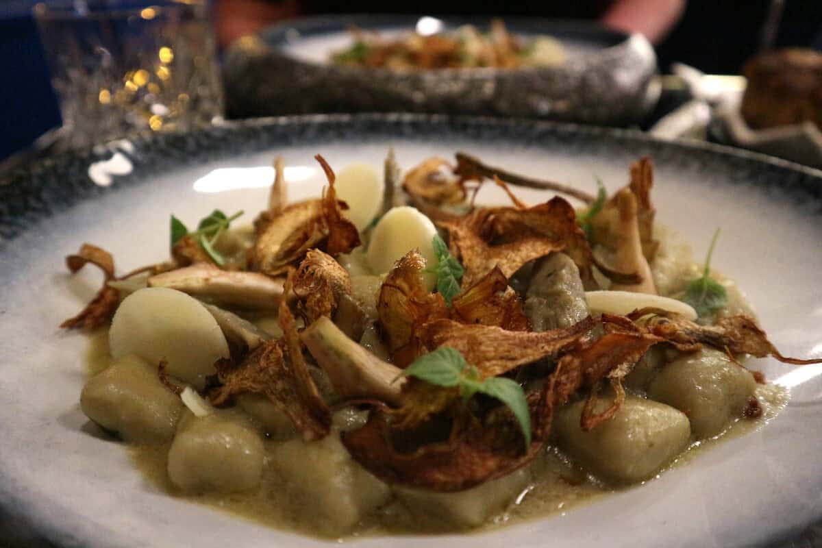 A close up of a beautifully presented gnocchi vegetarian dish at Les Foodies.