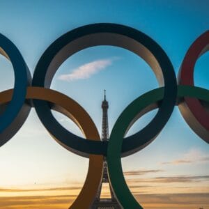 the olympic rings in front of the eiffel tower.