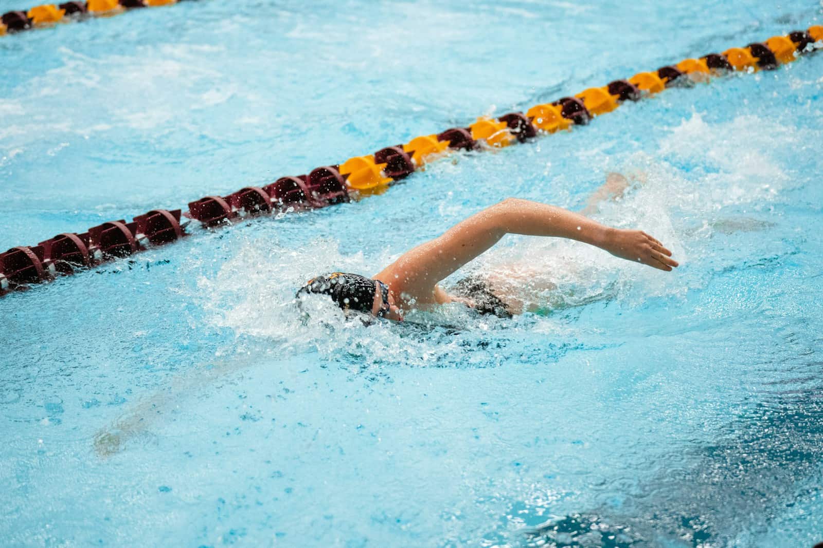 A person swimming in a swimming pool.