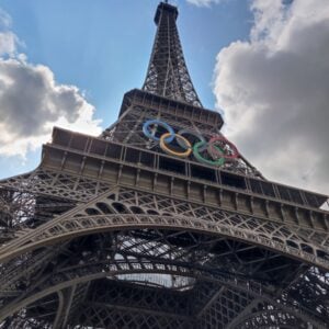 The eiffel tower with the olympic logo on it.