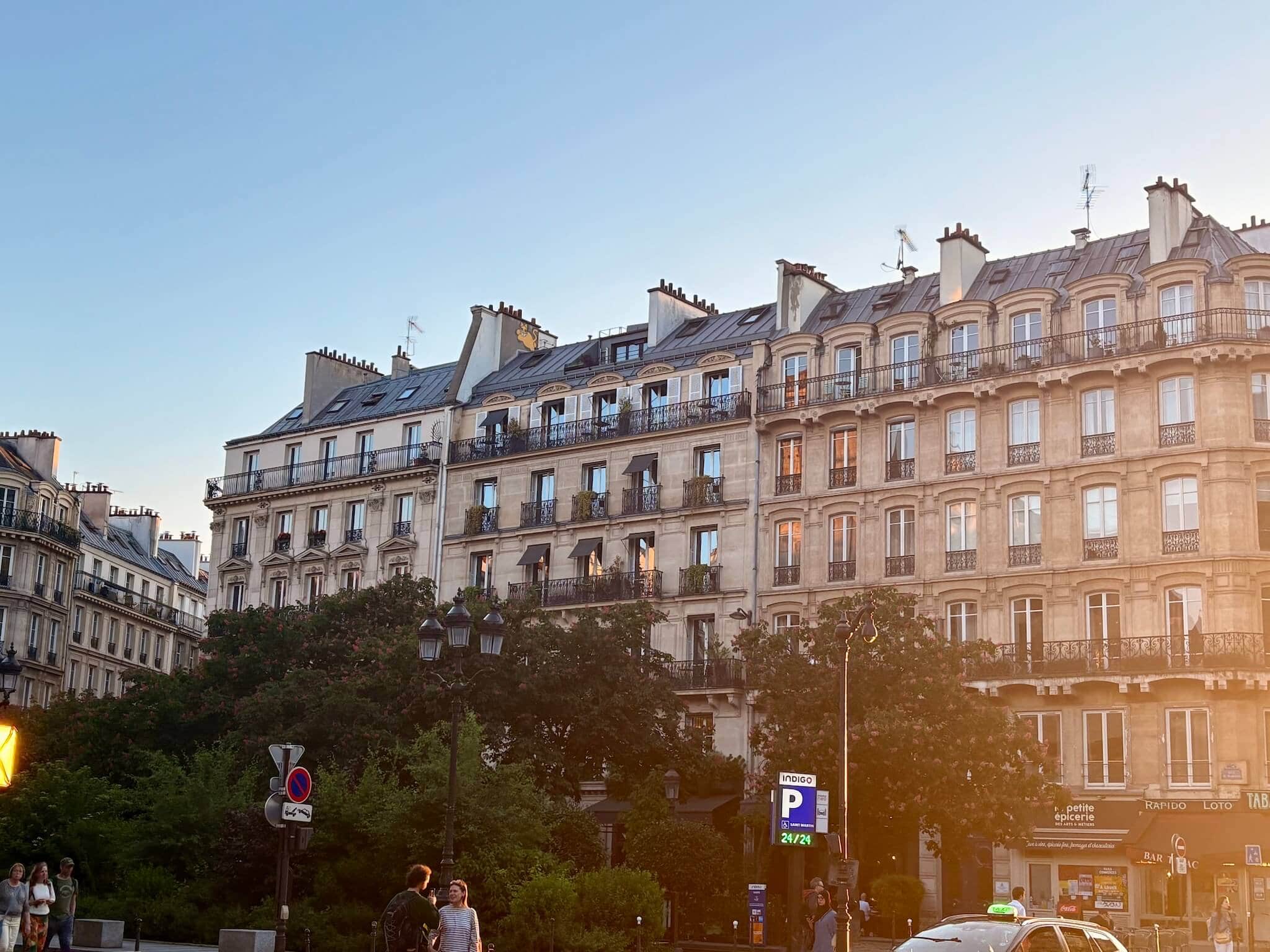 Haussmanian building rising above the treetops.